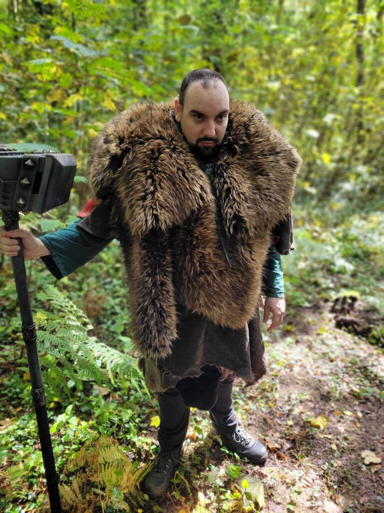 A player wearing furs holding a giant hammer