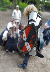 Photo of a knightly character guarding a group of others