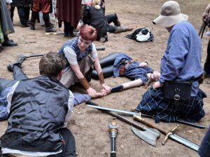 image of a magical ritual. a character symbolically links hte hands of two others,